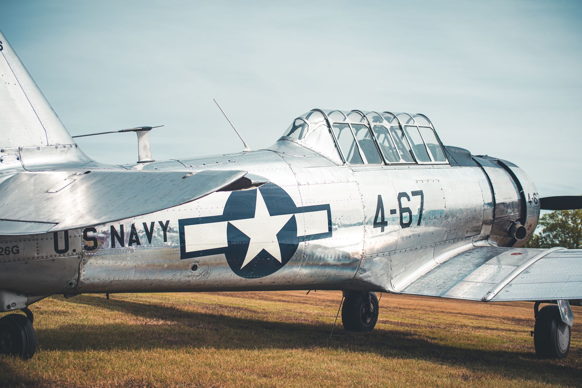 vintage u s navy aircraft on grass